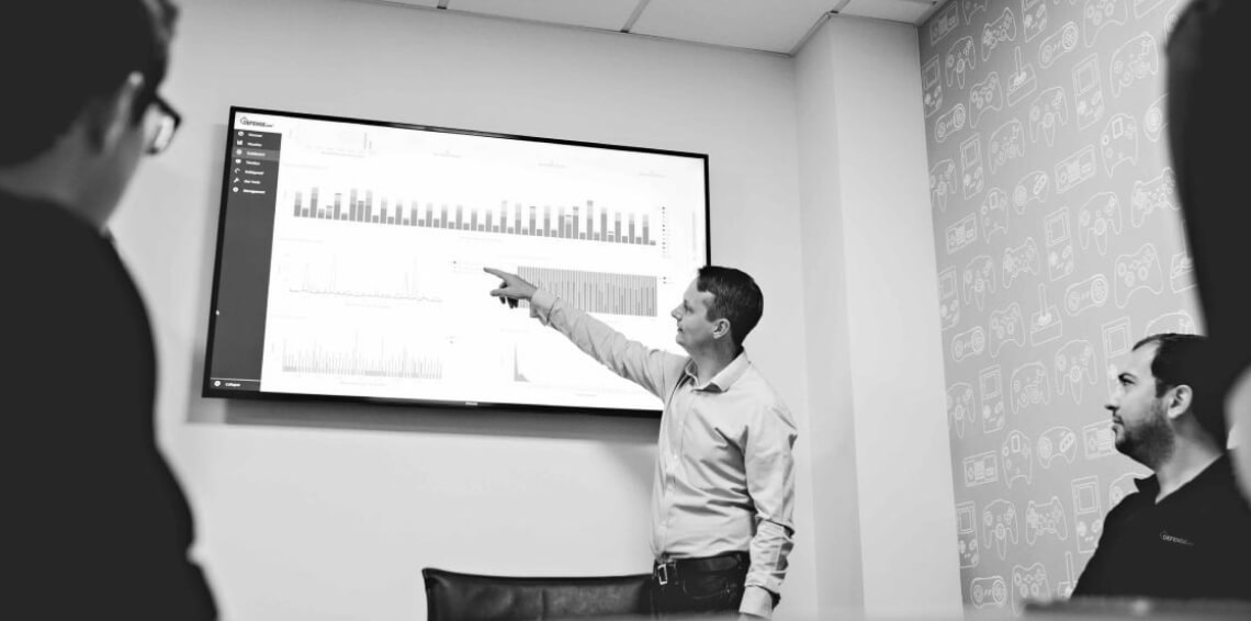 The Defense.com team looking at the Defense.com dashboard
